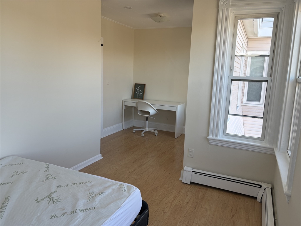 2 Sherman Street, Unit 2A3 Cambridge, MA 02138 - Photo 2 of 18 a bedroom with a bed and a window