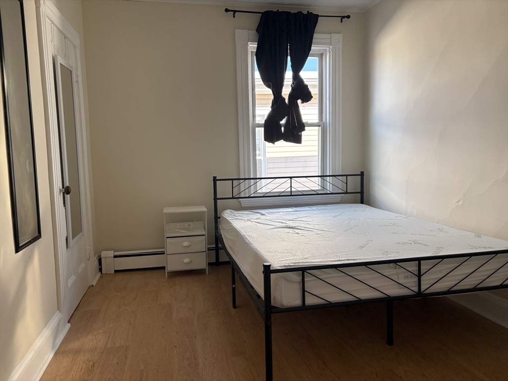 2 Sherman Street, Unit 2A3 Cambridge, MA 02138 - Photo 3 of 18 a view of a room that has a bed and a window