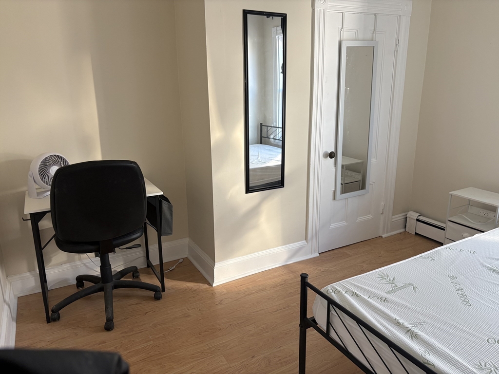 2 Sherman Street, Unit 2A3 Cambridge, MA 02138 - Photo 4 of 18 a view of a workspace room with wooden floor and furniture