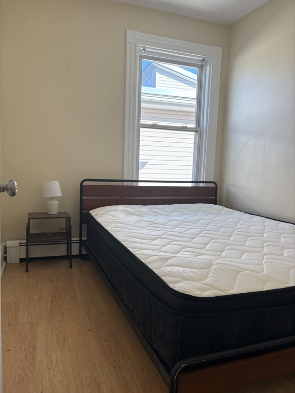 2 Sherman Street, Unit 2A3 Cambridge, MA 02138 - Photo 7 of 18 a bed sitting in a bedroom next to a window