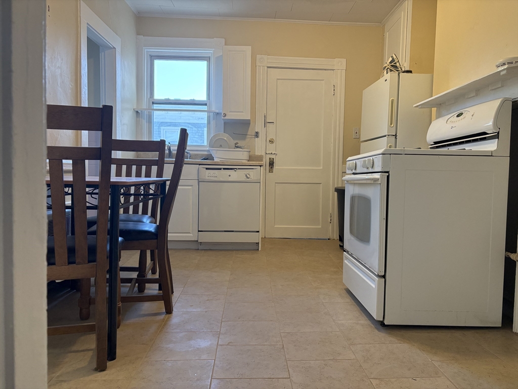 2 Sherman Street, Unit 2A3 Cambridge, MA 02138 - Photo 9 of 18 a room with furniture a washer and dryer