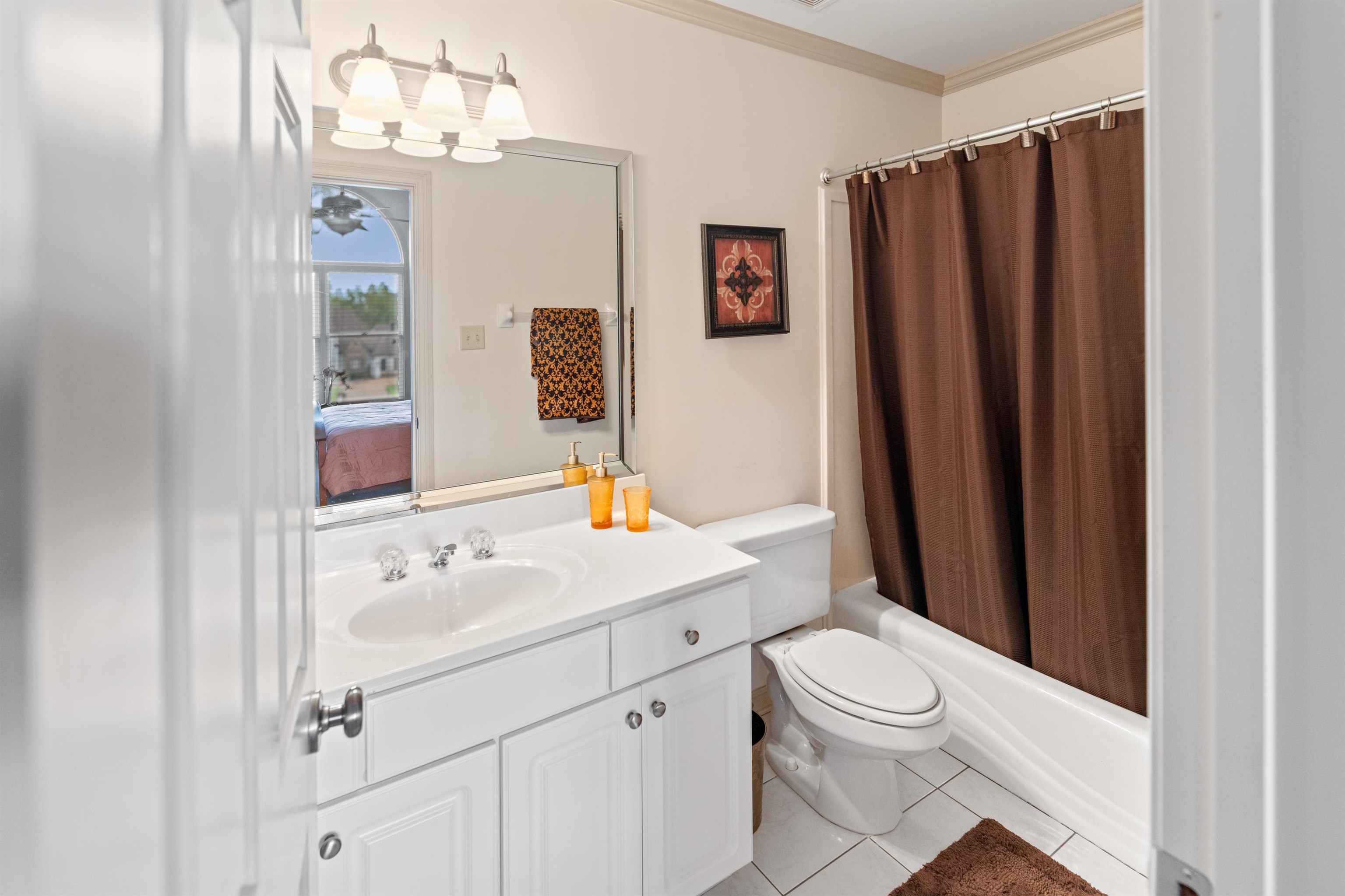 11241 Latting Road Eads, TN 38028 - Photo 27 of 31 Full bathroom featuring shower / tub combo, vanity, tile patterned flooring, ornamental molding, and toilet