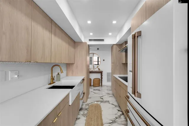 a kitchen with sink cabinets and appliances