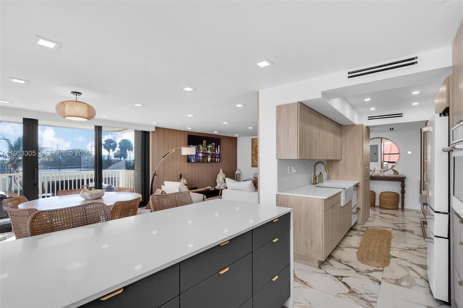 5480 North Ocean Drive, Unit B1B Singer Island, FL 33404 - Photo 12 of 41 a large kitchen with a large counter top appliances and cabinets