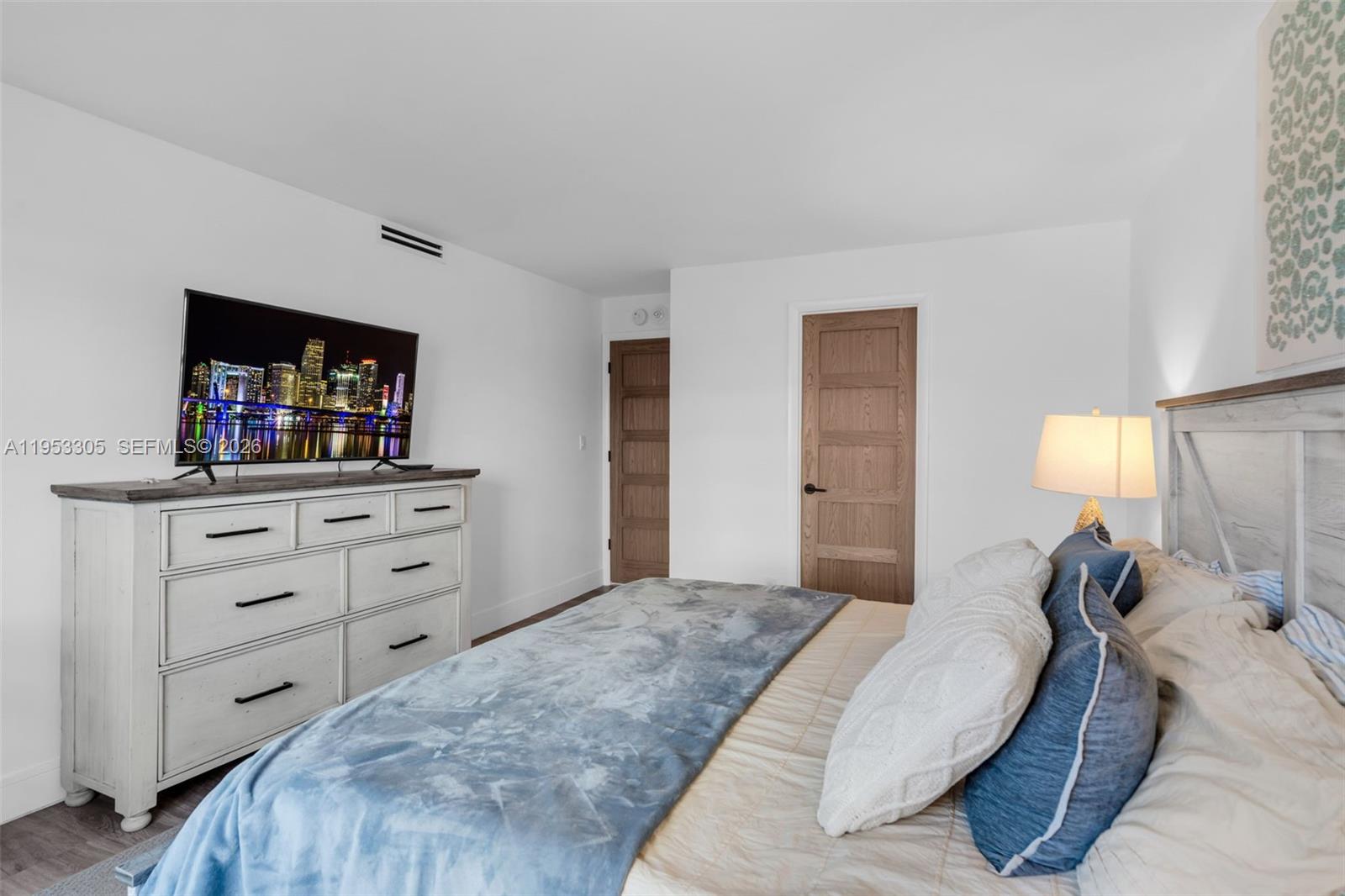 5480 North Ocean Drive, Unit B1B Singer Island, FL 33404 - Photo 14 of 41 a bedroom with a bed and a flat screen tv