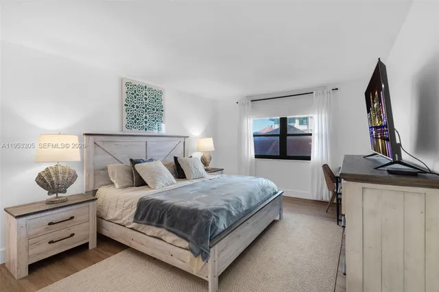 a bedroom with a bed and dresser