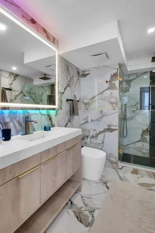 a bathroom with a sink toilet and shower