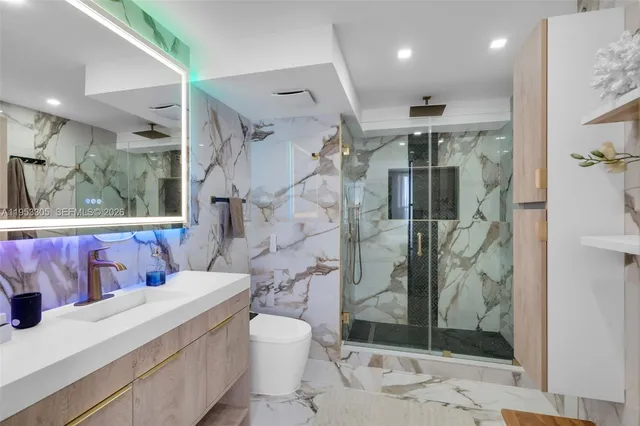 a bathroom with a sink toilet and shower