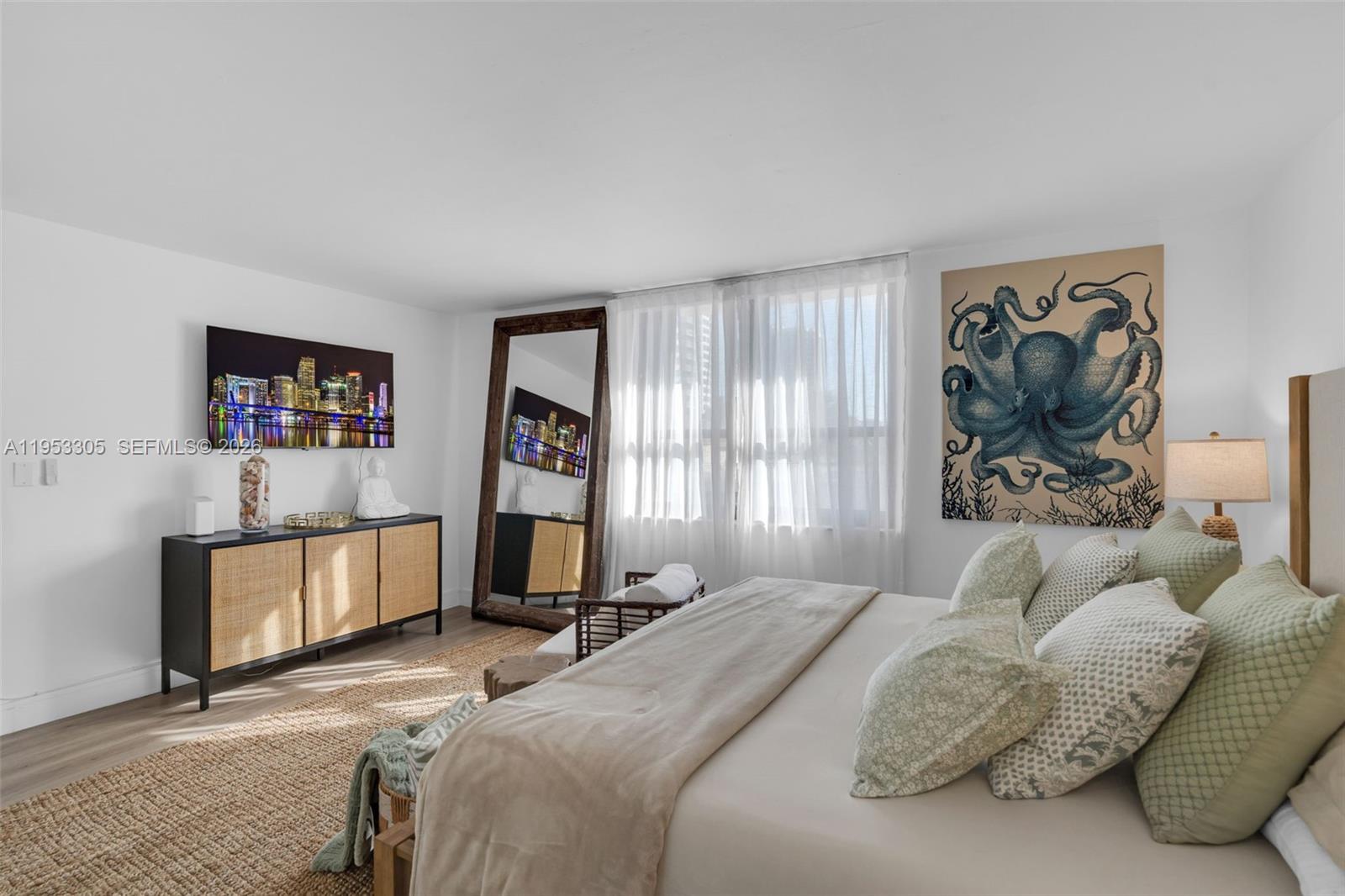 5480 North Ocean Drive, Unit B1B Singer Island, FL 33404 - Photo 19 of 41 a bedroom with a bed and a painting on the wall