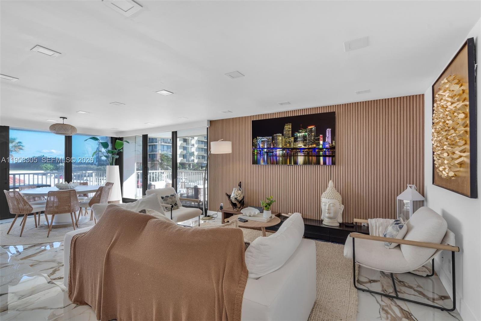 5480 North Ocean Drive, Unit B1B Singer Island, FL 33404 - Photo 2 of 41 a living room with furniture and a large window