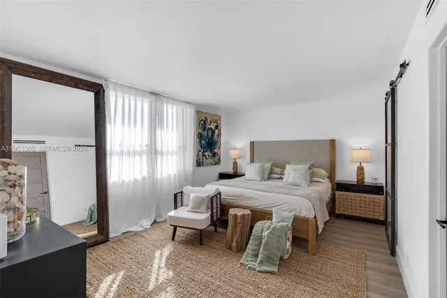 a bedroom with a bed and a couch