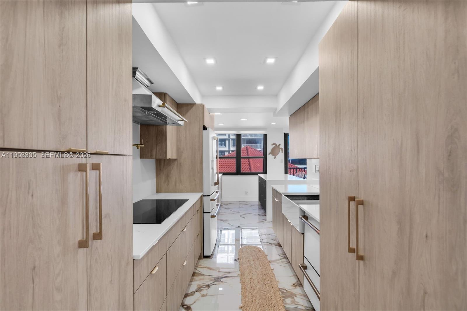 5480 North Ocean Drive, Unit B1B Singer Island, FL 33404 - Photo 22 of 41 a kitchen with stainless steel appliances a refrigerator and a sink