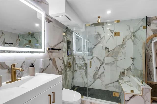 a bathroom with a sink toilet and shower