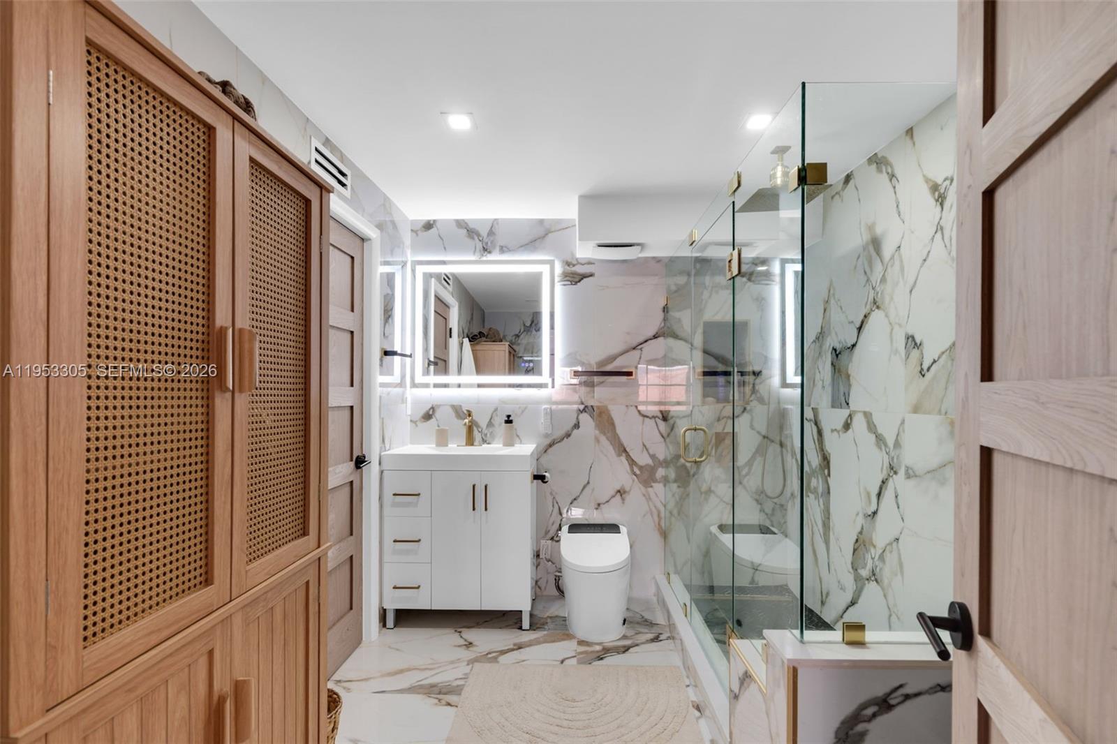 5480 North Ocean Drive, Unit B1B Singer Island, FL 33404 - Photo 37 of 41 a bathroom with a shower a sink and a mirror