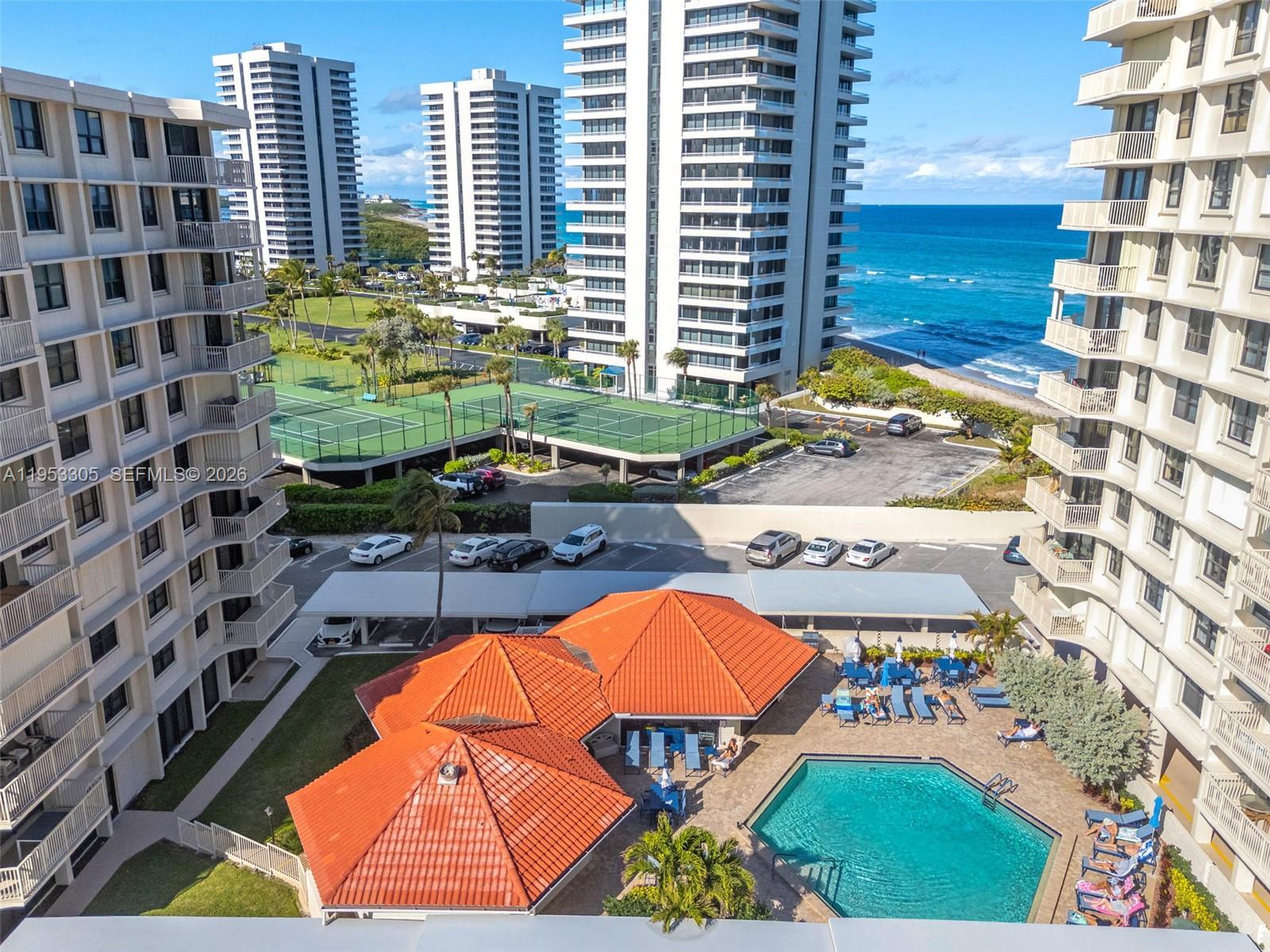 5480 North Ocean Drive, Unit B1B Singer Island, FL 33404 - Photo 39 of 41 a view of a swimming pool with a lounge chairs