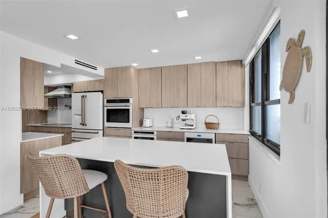 a kitchen with refrigerator and cabinets
