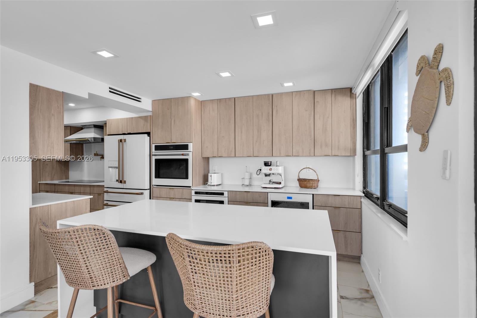 5480 North Ocean Drive, Unit B1B Singer Island, FL 33404 - Photo 4 of 41 a kitchen with refrigerator and cabinets