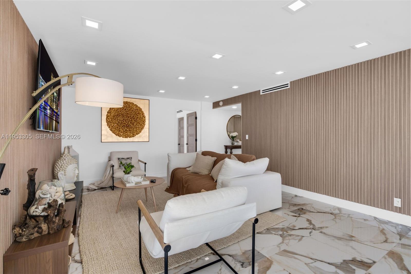 5480 North Ocean Drive, Unit B1B Singer Island, FL 33404 - Photo 9 of 41 a living room with a couch and a potted plant