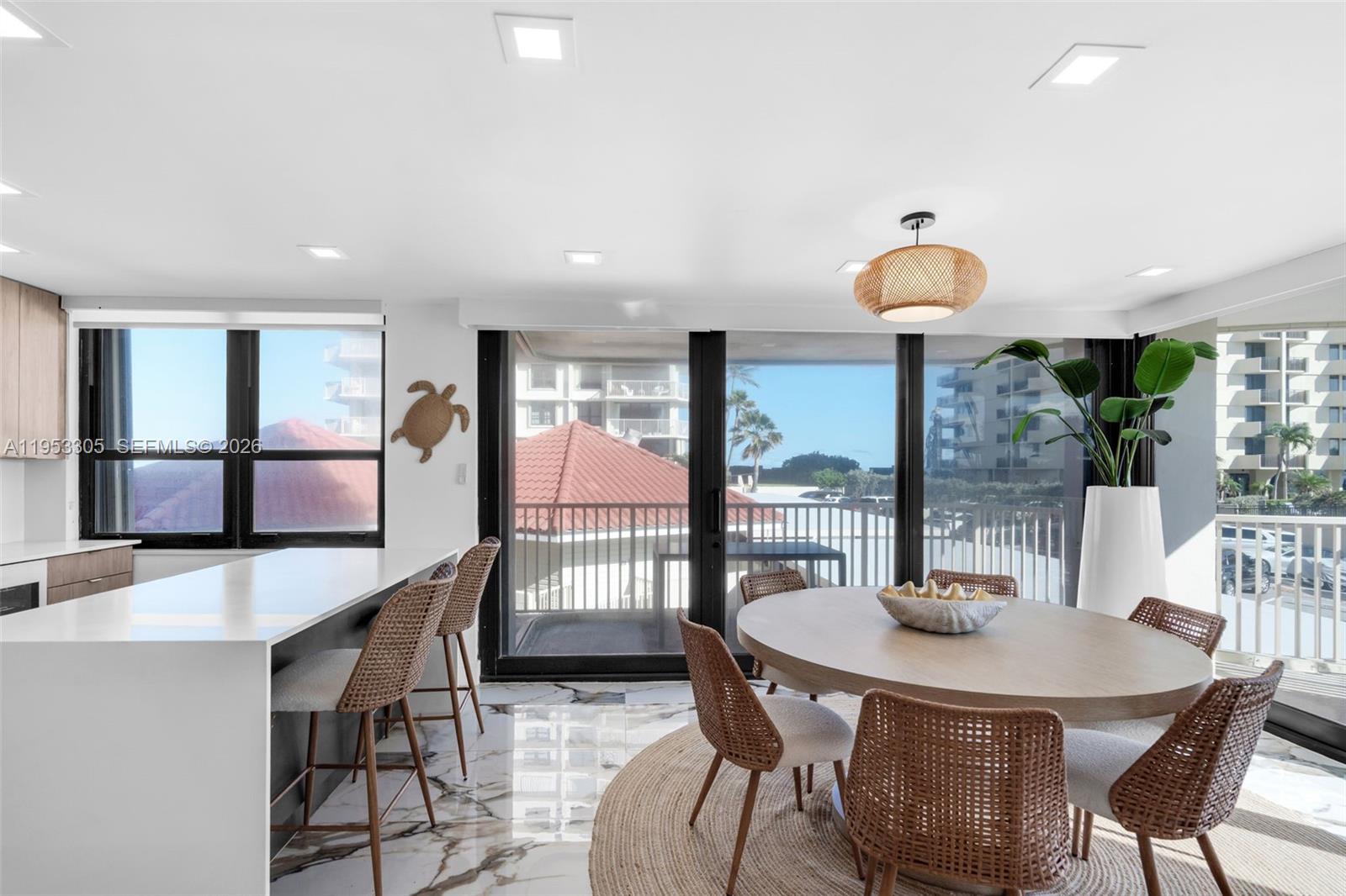 5480 North Ocean Drive, Unit B1B Singer Island, FL 33404 - Photo 10 of 41 a view of a dining room with furniture and a potted plant
