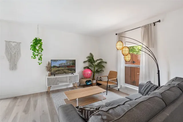 a backyard of a house with a tree and swing