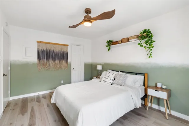 a bedroom with a bed and a chandelier