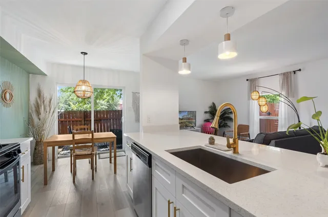 a backyard of a house with barbeque oven and trees