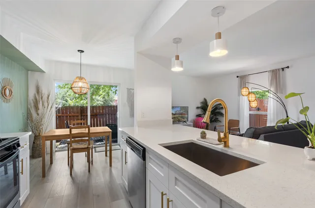 a backyard of a house with barbeque oven and trees