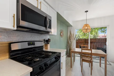 a kitchen with sink cabinets and dining table