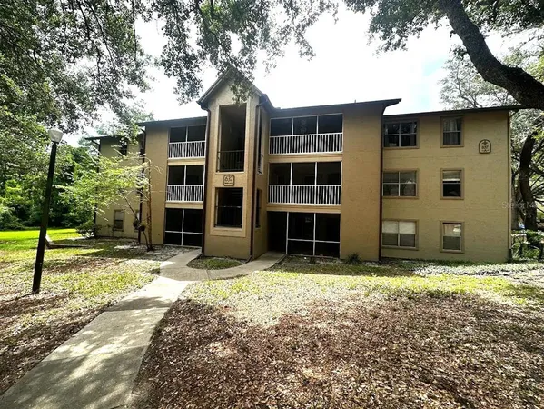 a tall house with trees in front of it