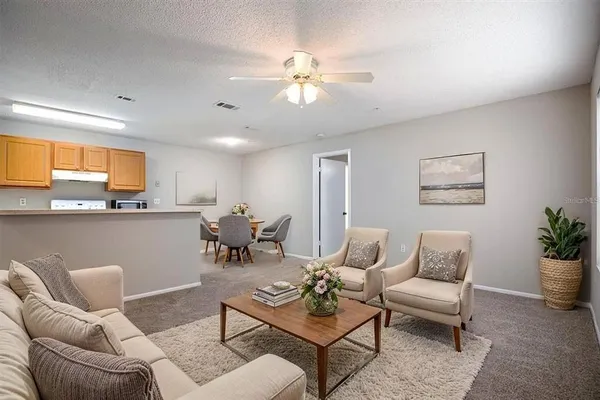 a view of a kitchen with a sink and a ceiling fan