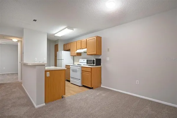 a kitchen with a sink stove top oven and microwave