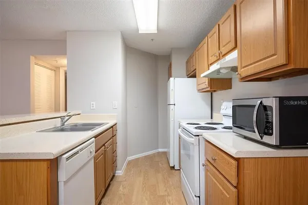 a kitchen that has a sink and a stove
