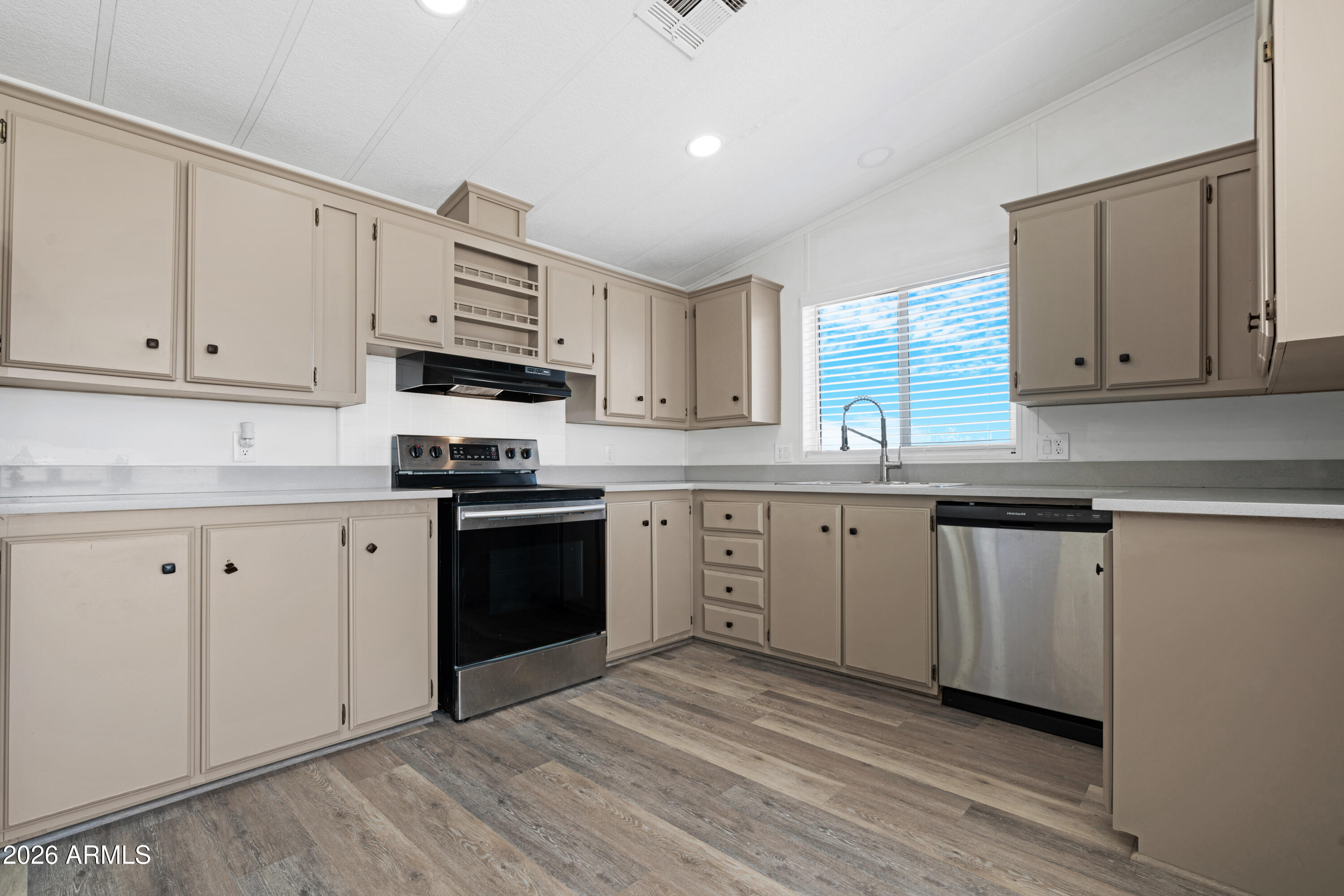 53925 West Stallion Road Maricopa, AZ 85139 - Photo 10 of 46 a kitchen with granite countertop white cabinets and white appliances