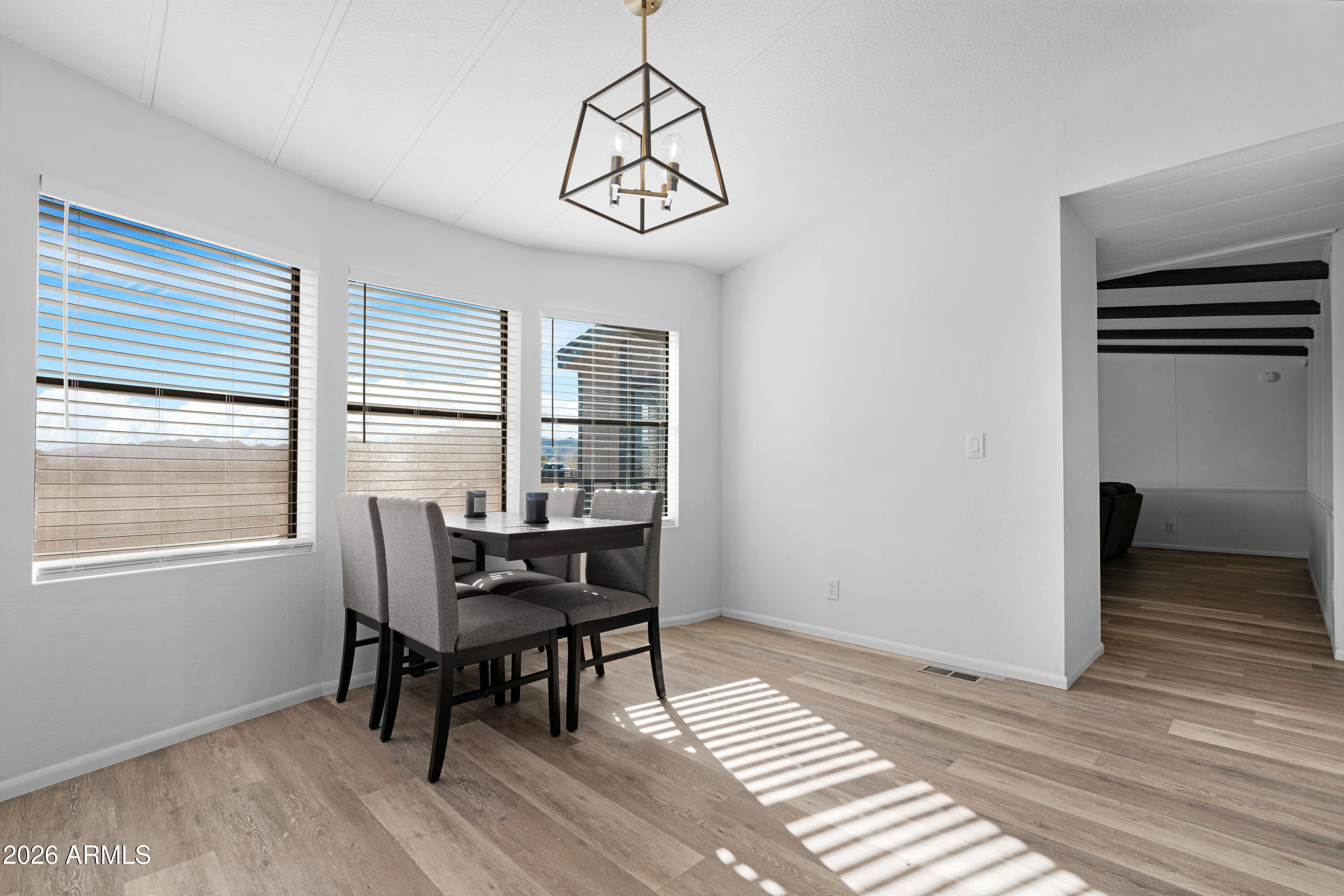 53925 West Stallion Road Maricopa, AZ 85139 - Photo 12 of 46 a view of a dining room with furniture window and wooden floor