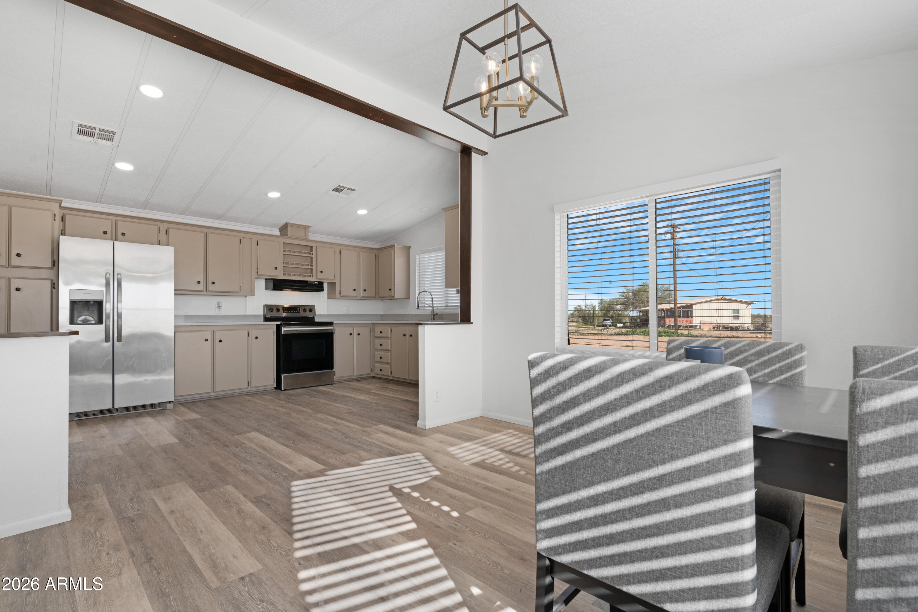 53925 West Stallion Road Maricopa, AZ 85139 - Photo 13 of 46 a kitchen with stainless steel appliances granite countertop a sink dishwasher a stove and a refrigerator with wooden floor