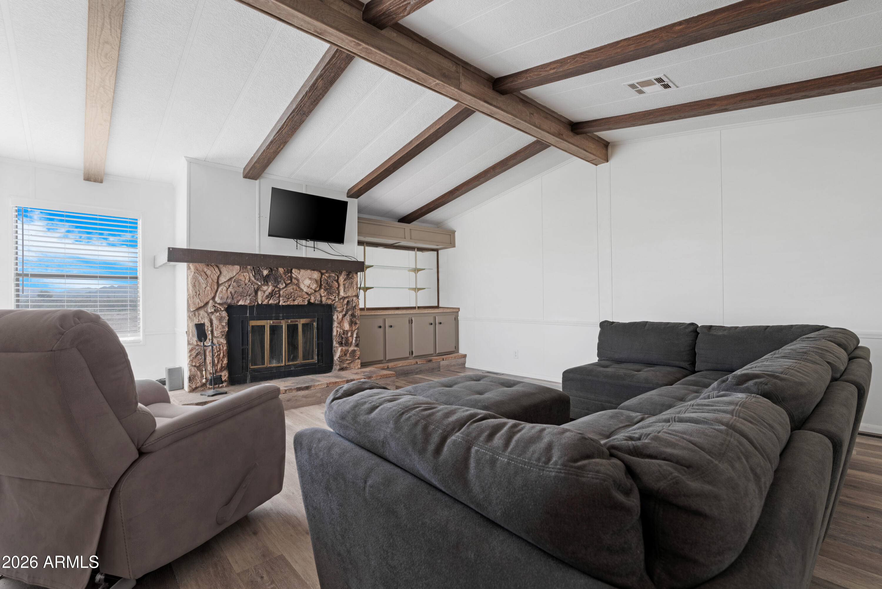 53925 West Stallion Road Maricopa, AZ 85139 - Photo 14 of 46 a living room with furniture and a fireplace