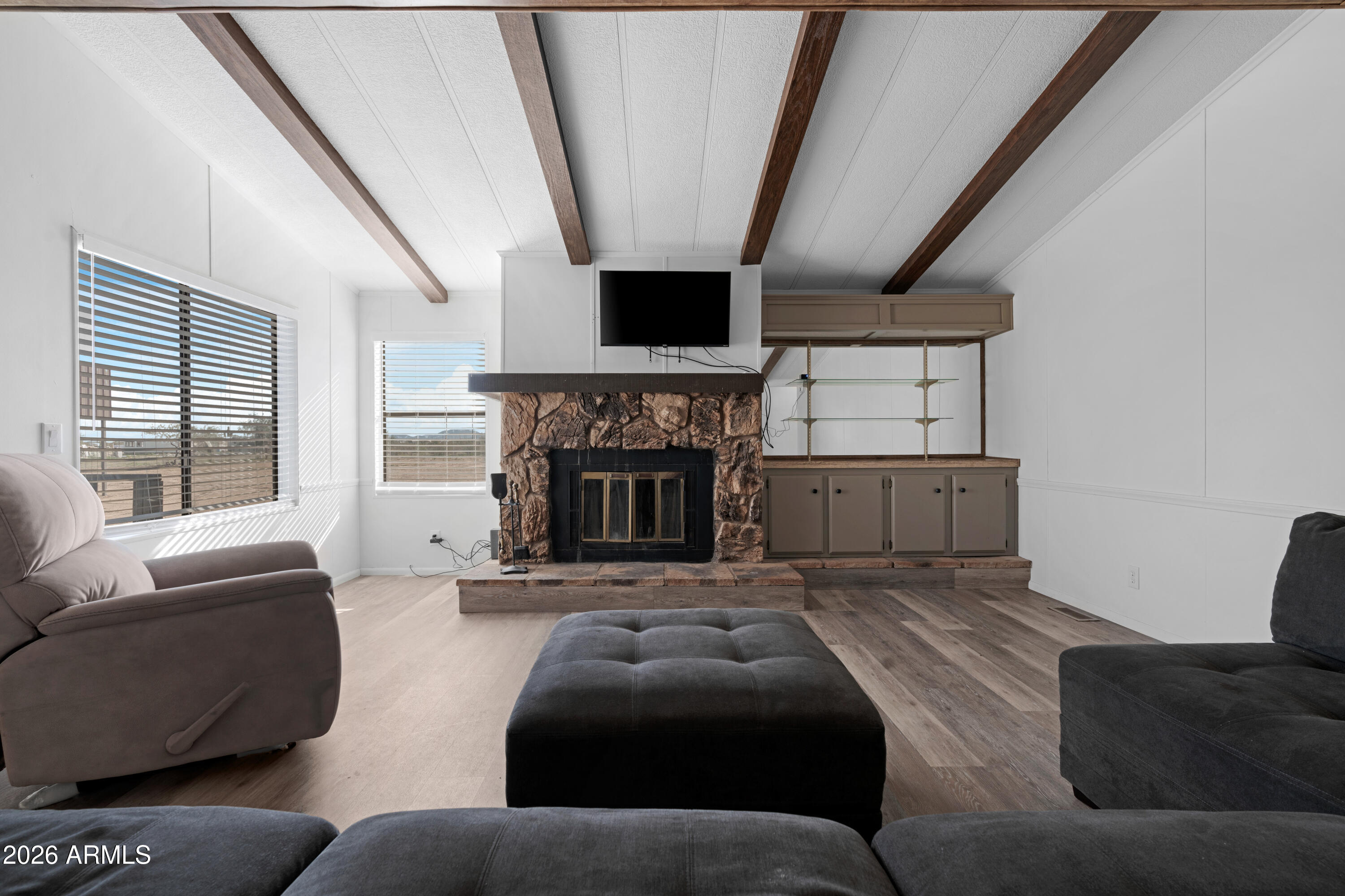53925 West Stallion Road Maricopa, AZ 85139 - Photo 15 of 46 a living room with furniture and a fireplace