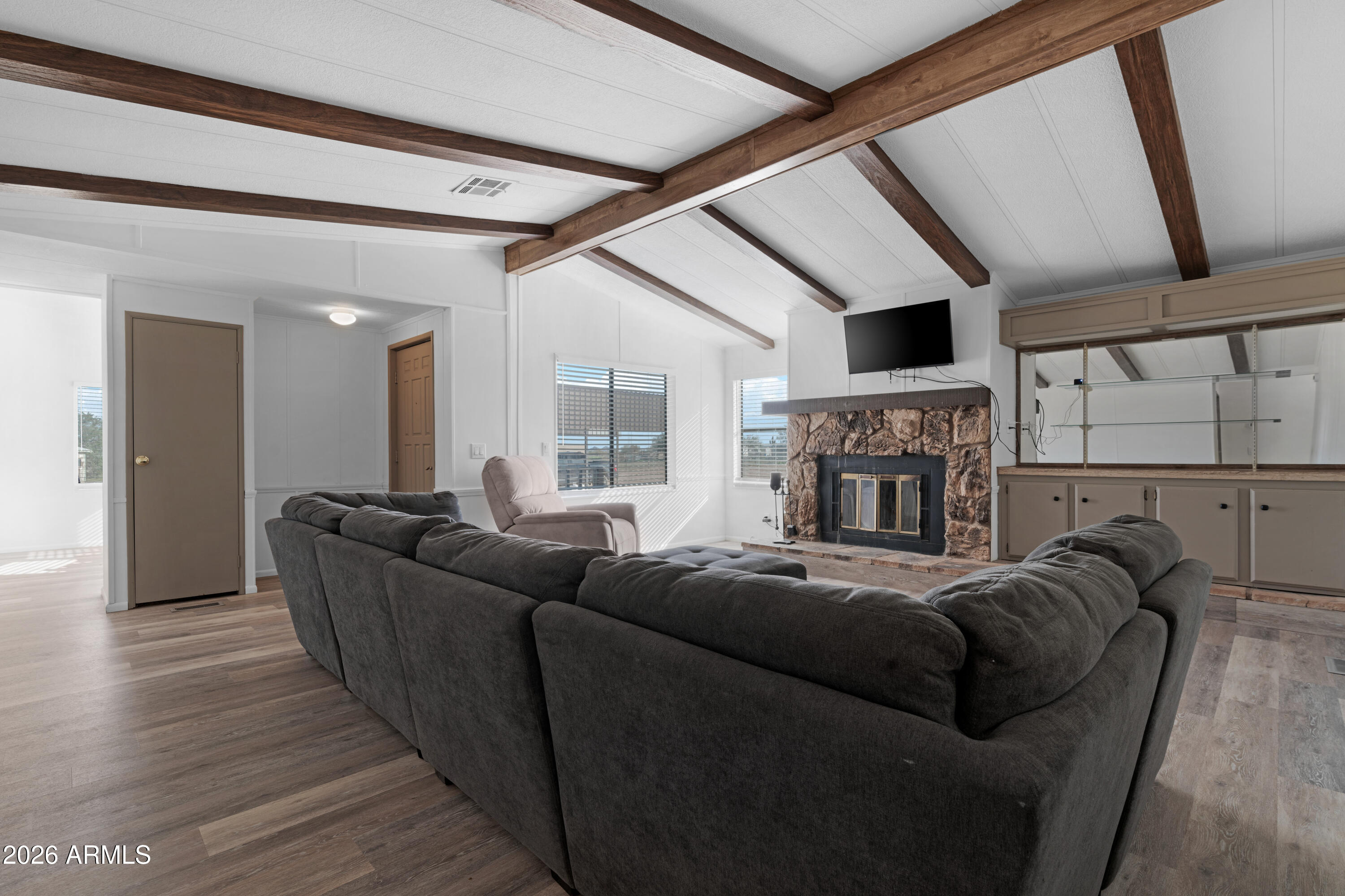 53925 West Stallion Road Maricopa, AZ 85139 - Photo 16 of 46 a living room with furniture and a fireplace