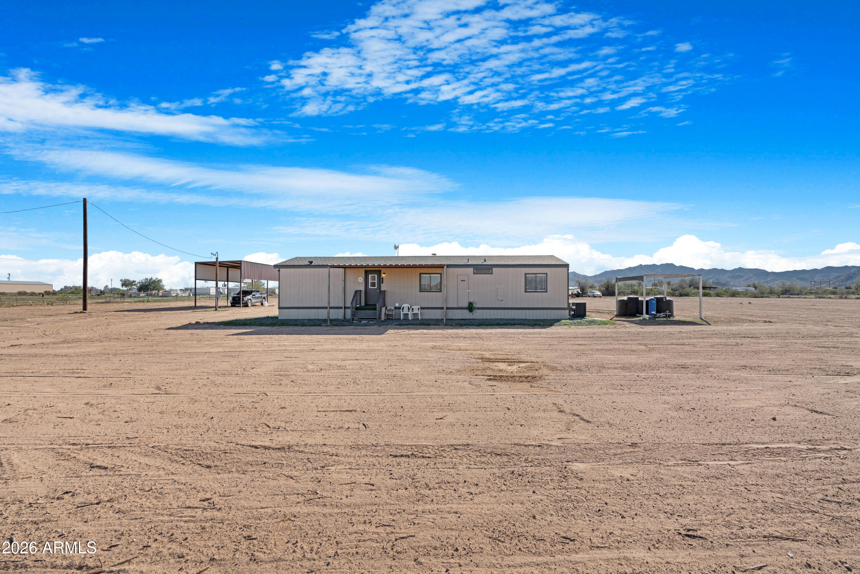 53925 West Stallion Road Maricopa, AZ 85139 - Photo 2 of 46 a house view with a big yard