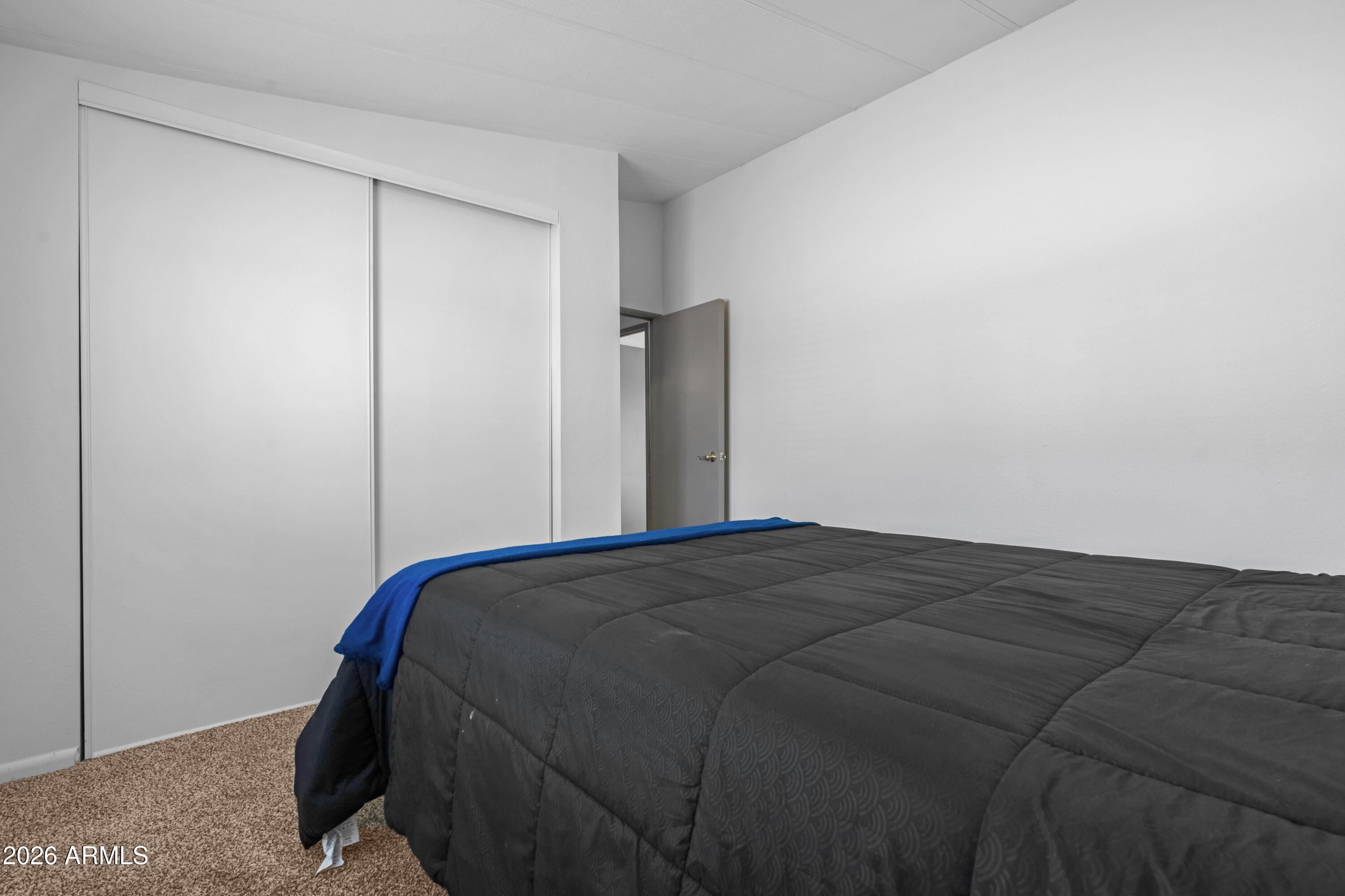 53925 West Stallion Road Maricopa, AZ 85139 - Photo 30 of 46 a bed sitting in a bedroom next to a cabinet