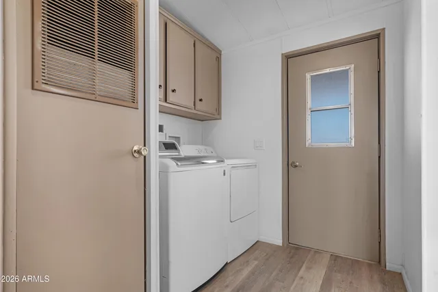 a bed sitting in a bedroom next to a cabinet