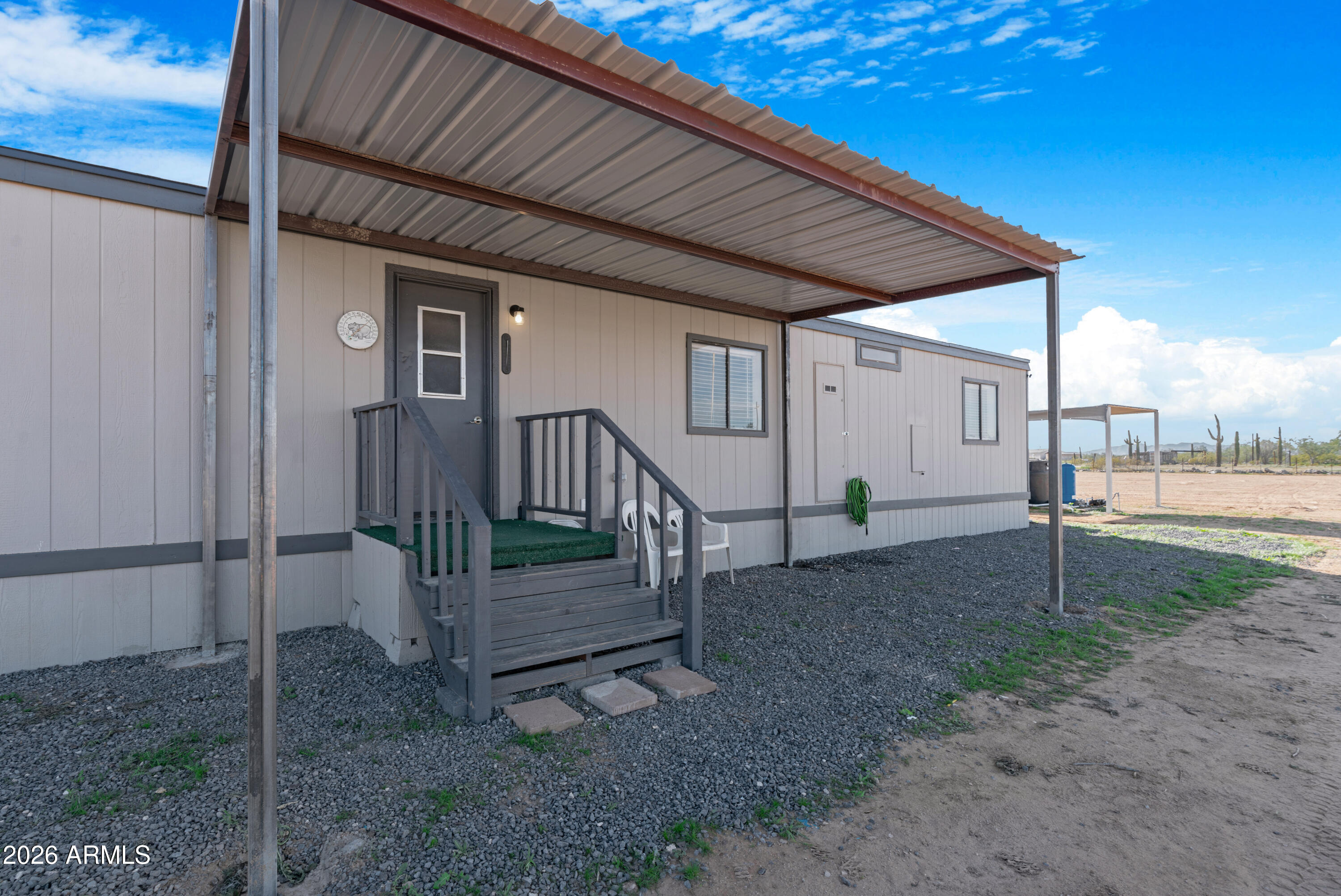 53925 West Stallion Road Maricopa, AZ 85139 - Photo 5 of 46 a view of a backyard with wooden fence