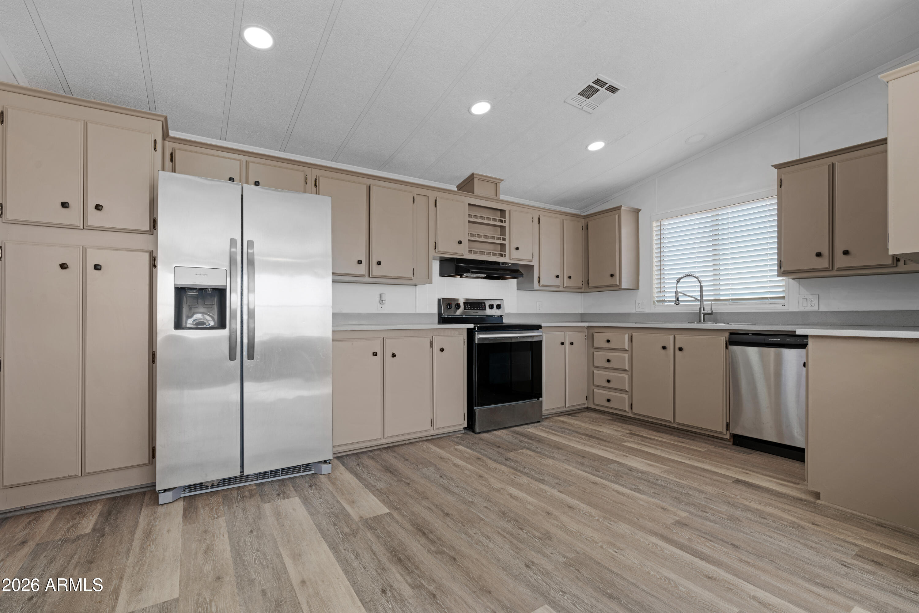 53925 West Stallion Road Maricopa, AZ 85139 - Photo 6 of 46 a kitchen with stainless steel appliances granite countertop a refrigerator sink and cabinets