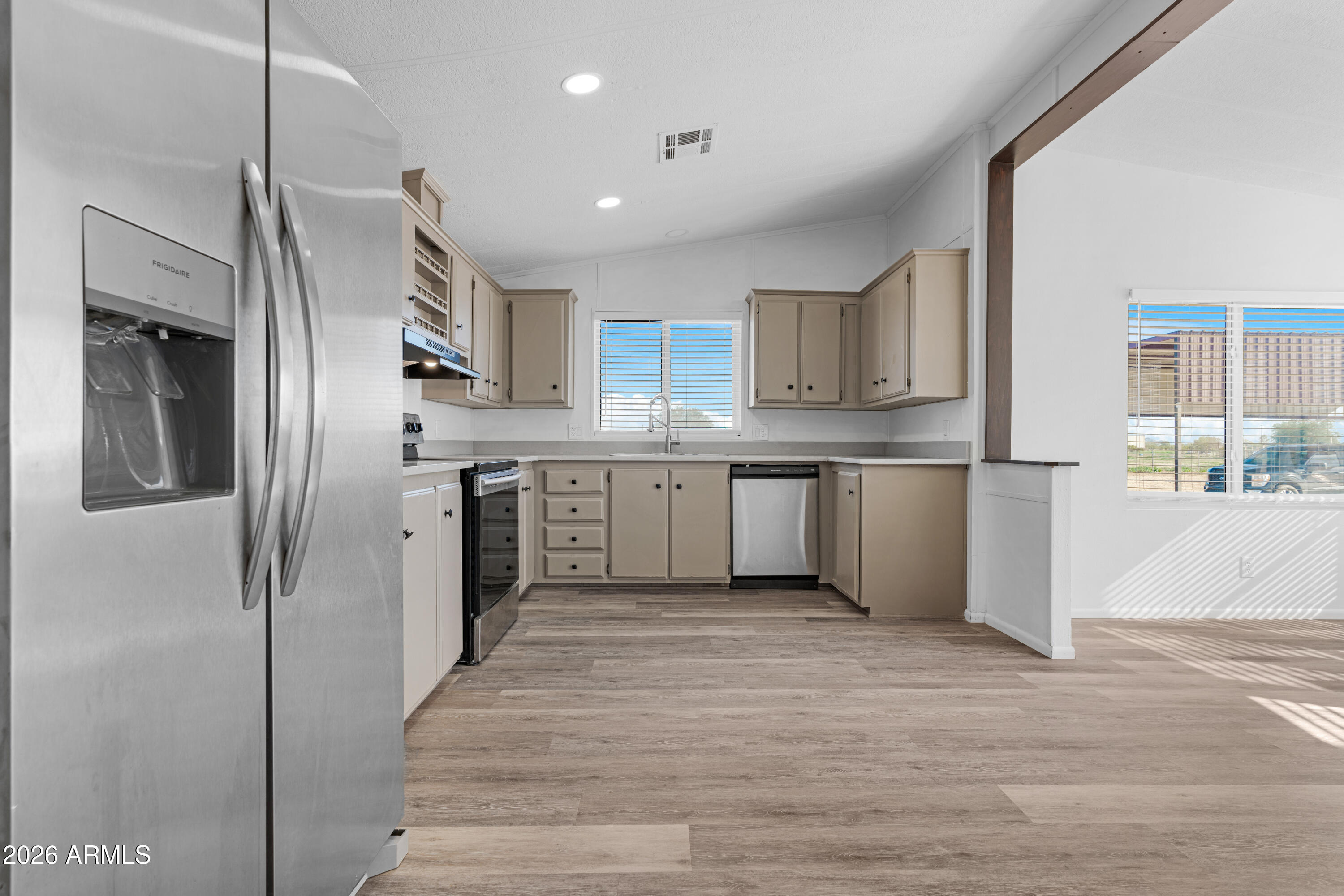 53925 West Stallion Road Maricopa, AZ 85139 - Photo 7 of 46 a kitchen with stainless steel appliances granite countertop a refrigerator and a stove top oven