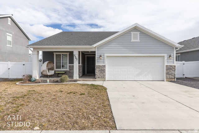 3347 South Boots Way Syracuse, UT 84075 - Photo 1 of 1 View of front facade with a gate, a porch, stone siding, and concrete driveway