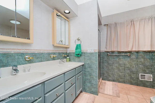 a living room with furniture a chandelier a rug and a clock