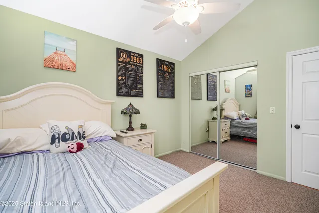 a living room with furniture a flat screen tv and kitchen view