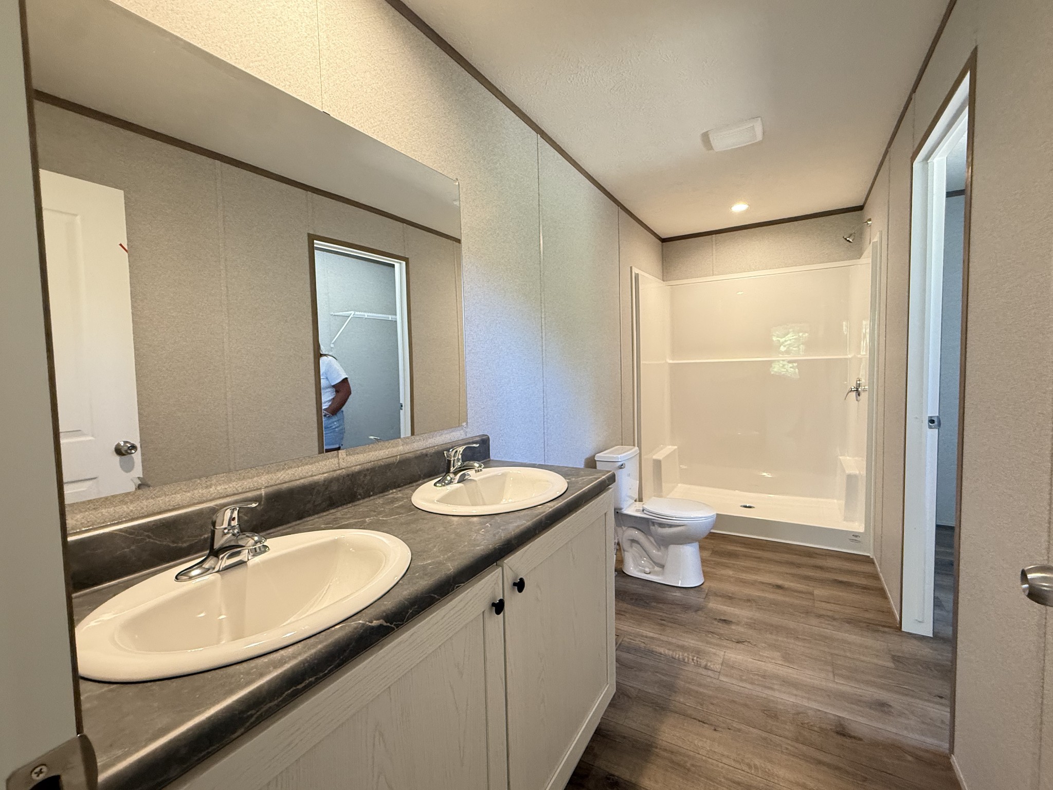 467 Woodland Road Hohenwald, TN 38462 - Photo 11 of 20 a bathroom with a double vanity sink toilet and a mirror