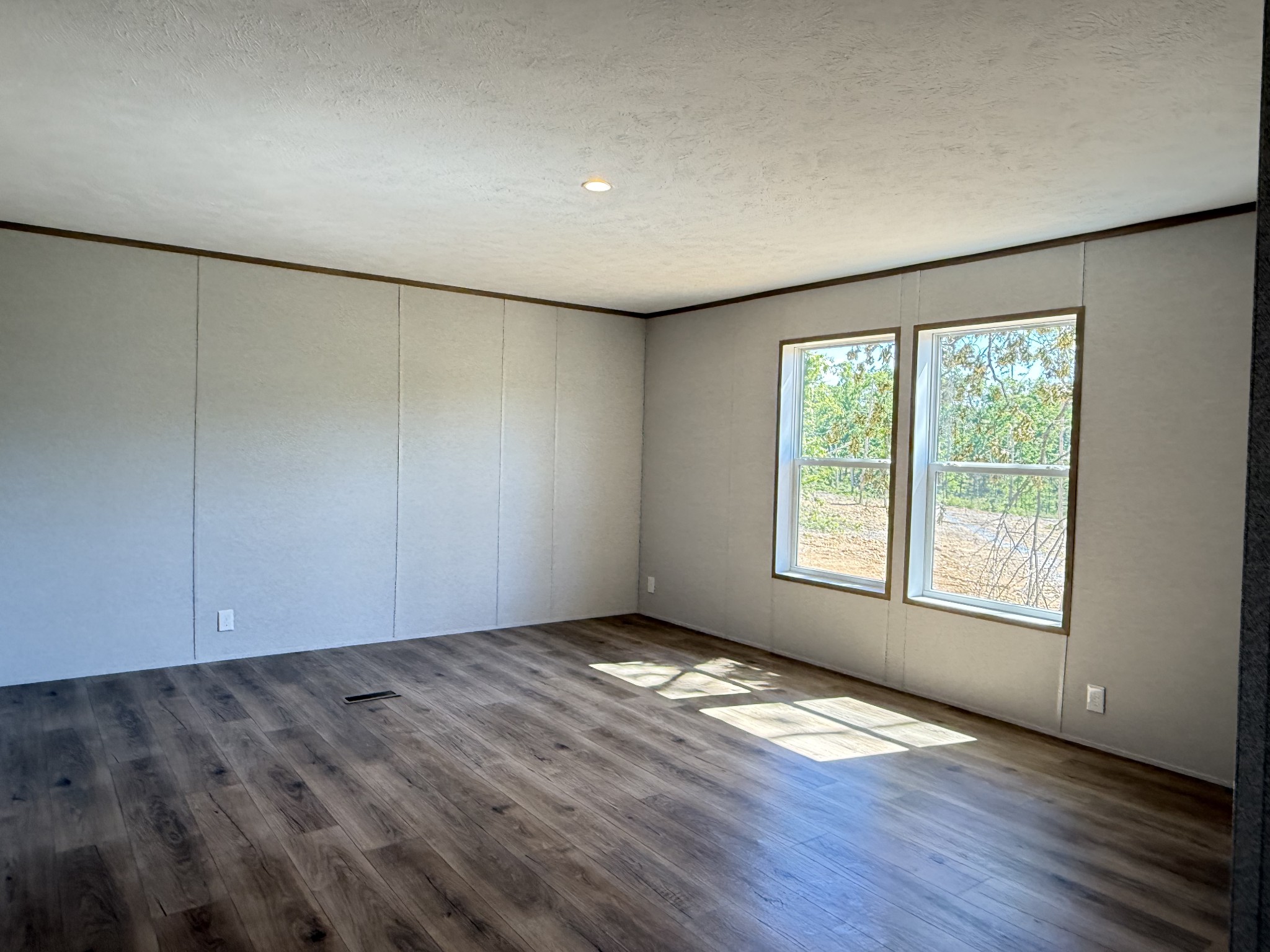 467 Woodland Road Hohenwald, TN 38462 - Photo 15 of 20 an empty room with wooden floor and windows