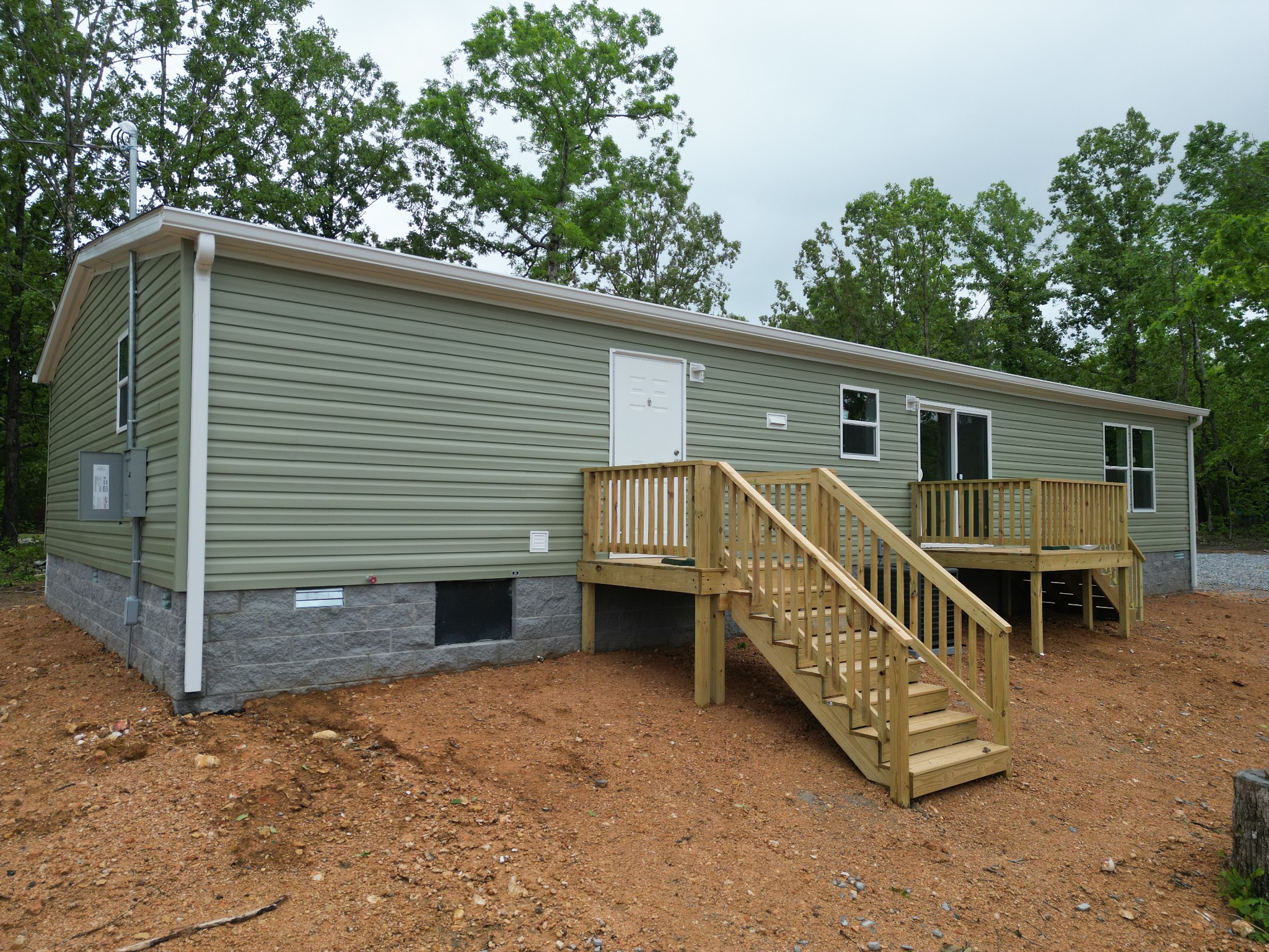 467 Woodland Road Hohenwald, TN 38462 - Photo 18 of 20 a view of a house with a balcony and chairs in patio